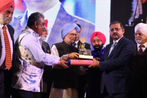 Jewel of Punjab award being given by Ex-PM India, Dr Manmohan Singh